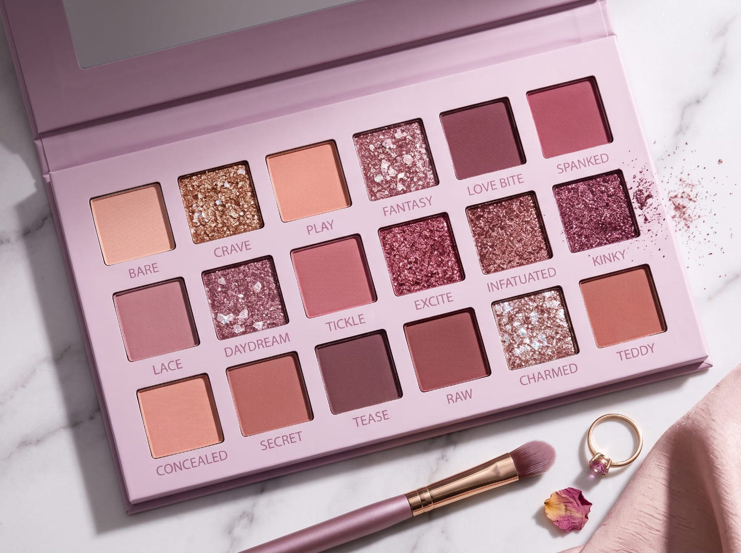 Eyeshadow palette with shade names: Bare, Crave, Play, Fantasy and more