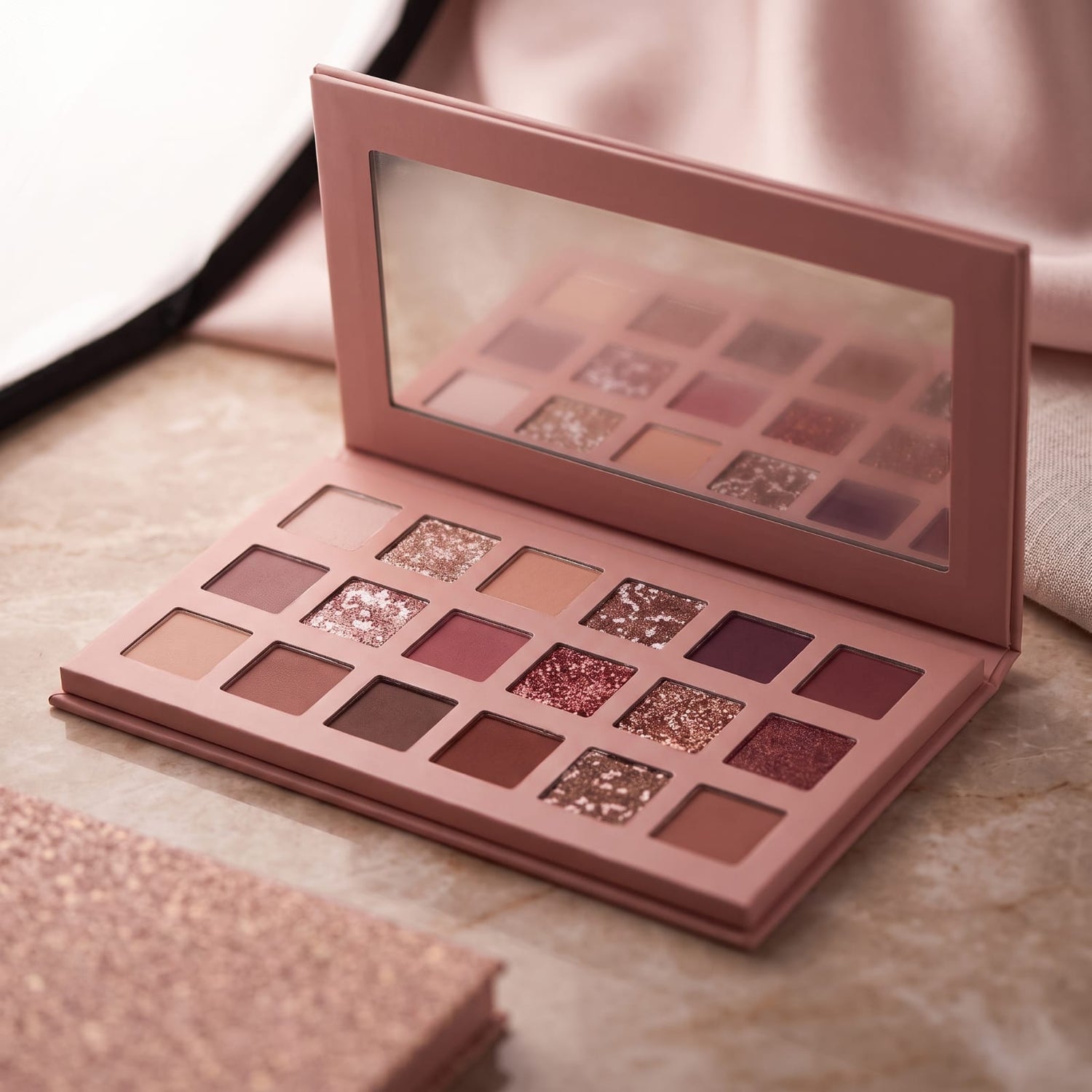 18-pan rose nude eyeshadow palette open showing matte and glitter shades