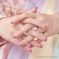 French tip nails on pink fabric